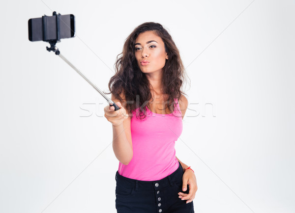 Woman making selfie photo on smartphone with stick Stock photo © deandrobot