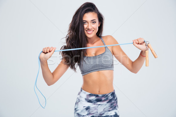 Charming woman holding skipping rope Stock photo © deandrobot