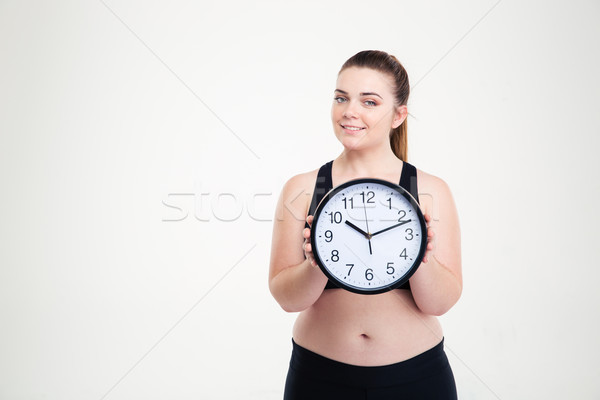 Stock photo: Happy fat woman holding clock