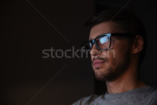 Handsome man in glasses looking at screen  Stock photo © deandrobot