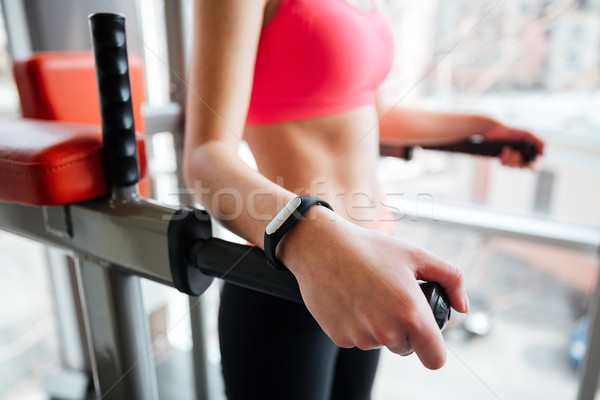 Woman athlete with fitness tracker on hand working out  Stock photo © deandrobot