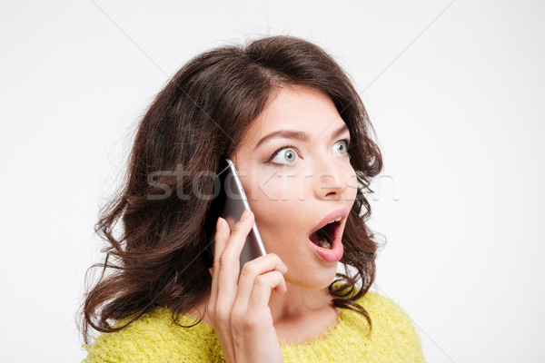 Stock photo: Amazed woman talking on the phone