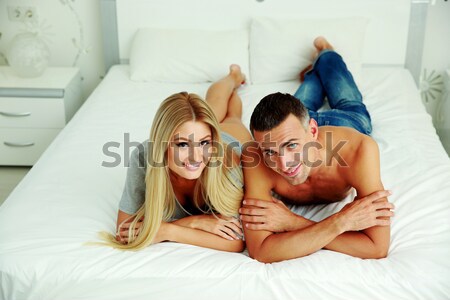Stock photo: Two happy lovely sisters sitting and hugging at home 