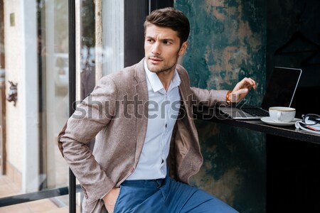 Man relaxing and reading magazine in outdoor cafe Stock photo © deandrobot