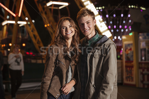 Joyful young couple in amusement park Stock photo © deandrobot
