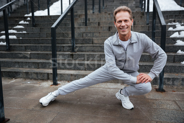 Full length runner warming up near the stairs Stock photo © deandrobot