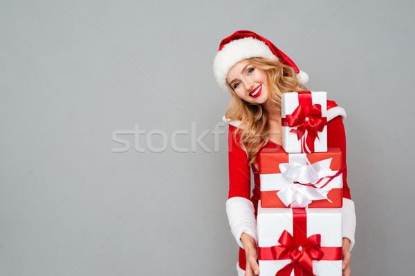 Woman in red hat holding stack of gift boxes Stock photo © deandrobot