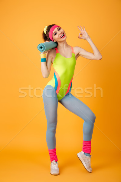 Joli jeunes sport femme posant jaune [[stock_photo]] © deandrobot