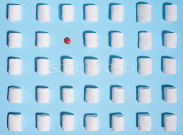 Sweeties marshmallows over blue table background. Stock photo © deandrobot