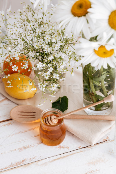 Citruses on table near honey Stock photo © deandrobot