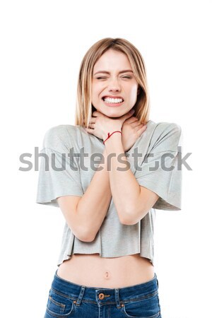 Confused young lady have a painful feelings and touching neck Stock photo © deandrobot