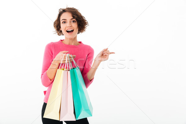 Portrait of a young happy girl holding shopping bags Stock photo © deandrobot