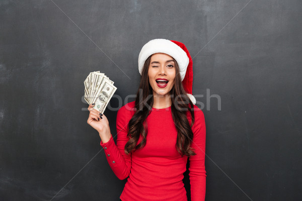 Funny brunette woman in red blouse and christmas hat Stock photo © deandrobot