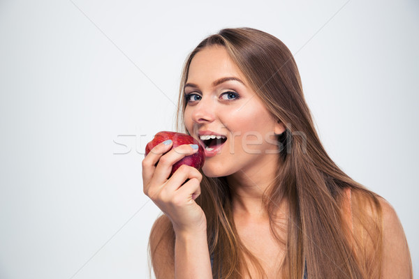 Porträt junge Mädchen beißen Apfel isoliert weiß Stock foto © deandrobot