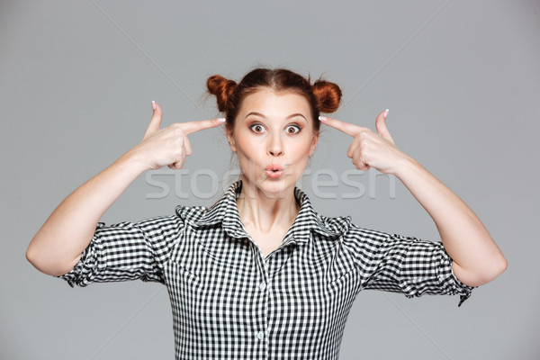 Joyeux femme pointant drôle de visage [[stock_photo]] © deandrobot