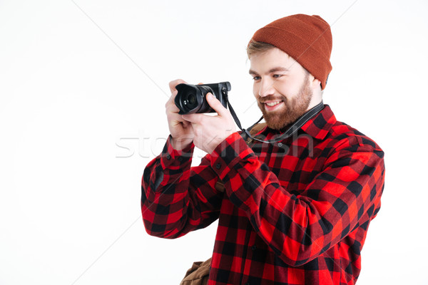 Young hipster guy taking picture with photo camera Stock photo © deandrobot