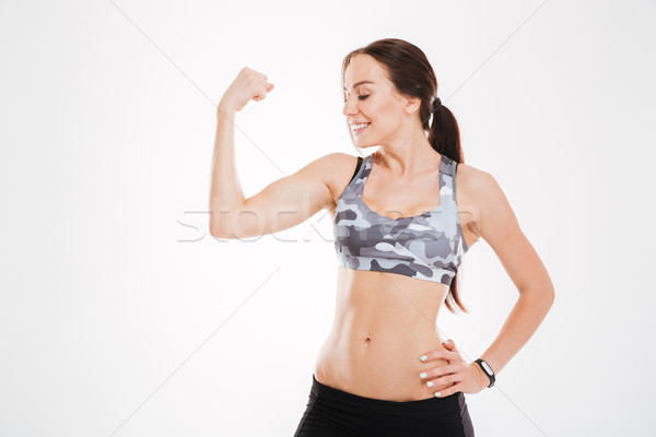 Fitnessz nő mutat stúdió izolált fehér mosoly Stock fotó © deandrobot