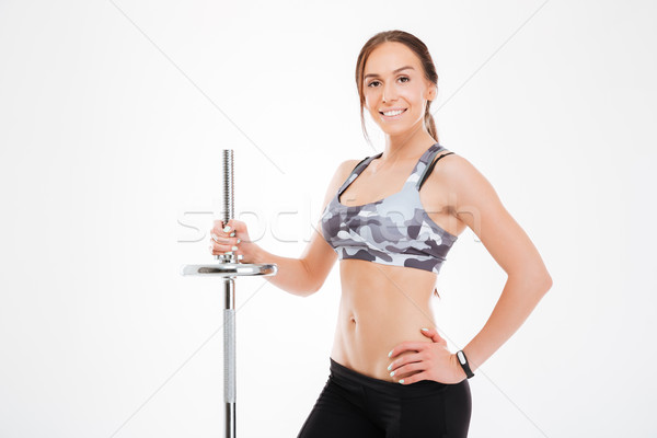 Smiling fitness girl with barbell Stock photo © deandrobot