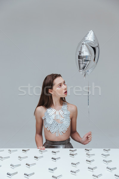 Nő tart léggömb ül asztal borotva Stock fotó © deandrobot