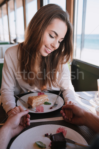 Verical image of shy woman on date in cafe Stock photo © deandrobot