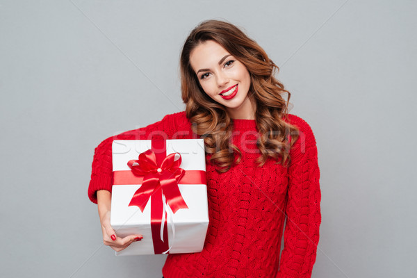 Young woman keeps a christmas gift Stock photo © deandrobot