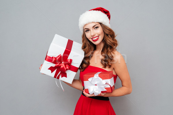 Smiling girl with red and white gift box Stock photo © deandrobot