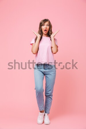 Playful lady holding candy and bite her lip. Stock photo © deandrobot