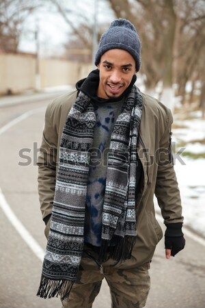 Happy african american young man standing outdoors Stock photo © deandrobot