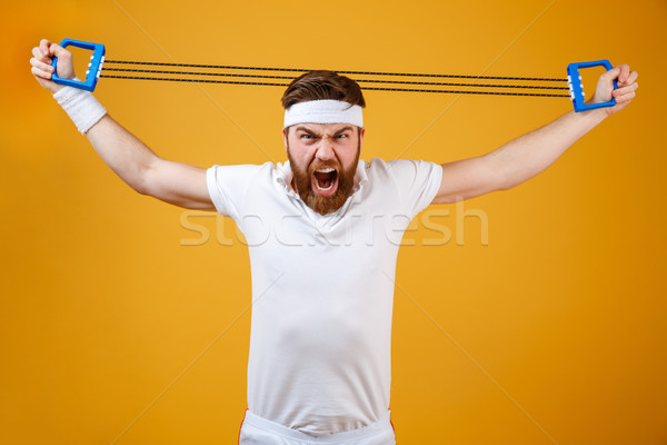 Screaming young sportsman make sport exercises Stock photo © deandrobot