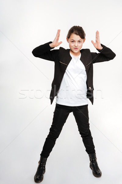 Happy young girl standing and posing Stock photo © deandrobot