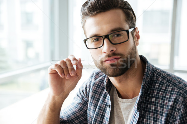 Handsome man wearing glasses sitting in office coworking Stock photo © deandrobot