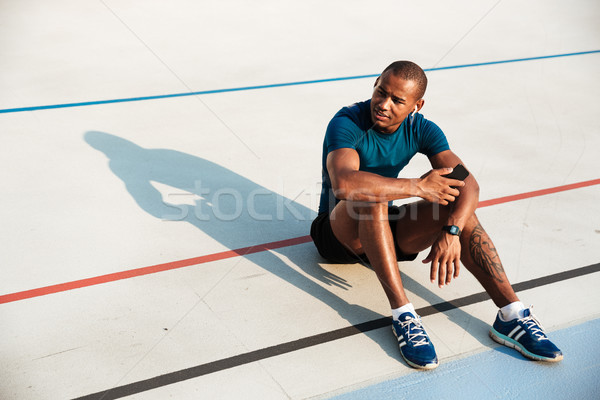 Portrait of a young motivated african fitness man in earphones Stock photo © deandrobot