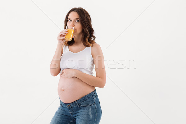 Pregnant woman standing isolated drinking juice Stock photo © deandrobot