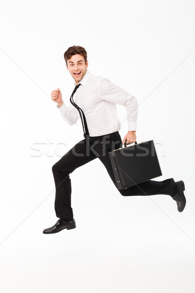 Full length portrait of a happy handsome businessman Stock photo © deandrobot