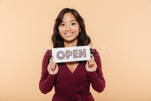 Portrait of beautiful woman in maroon dress being in good mood h Stock photo © deandrobot