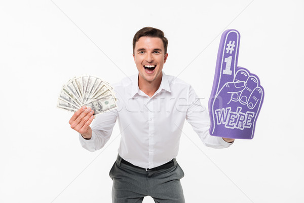 Portrait of an excited amused man in white shirt Stock photo © deandrobot