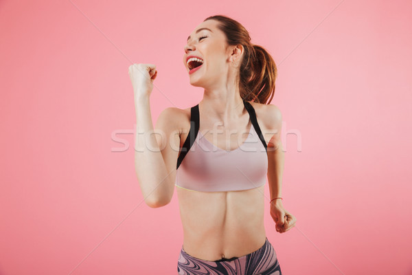 Image of Happy sportswoman running and enjoys while looking away Stock photo © deandrobot