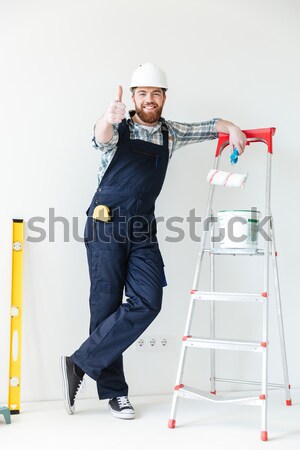 Businessman in helmet with blue folder over white background Stock photo © deandrobot