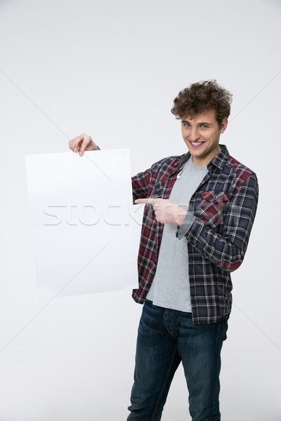 Derűs férfi göndör haj tart óriásplakát háttér Stock fotó © deandrobot