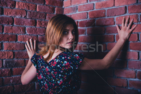 Portrait of a scared young woman Stock photo © deandrobot