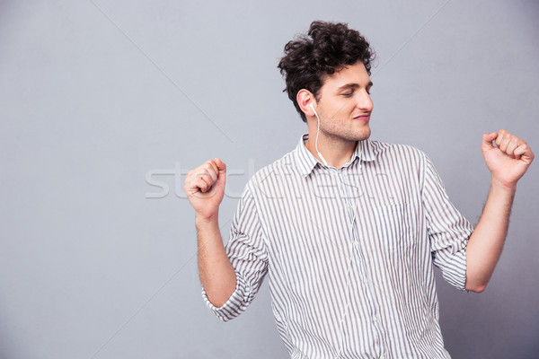 Man listening music in headphones Stock photo © deandrobot