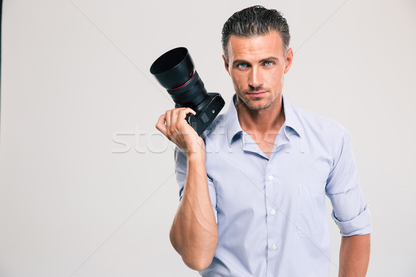 Porträt Mann halten Kamera isoliert weiß Stock foto © deandrobot