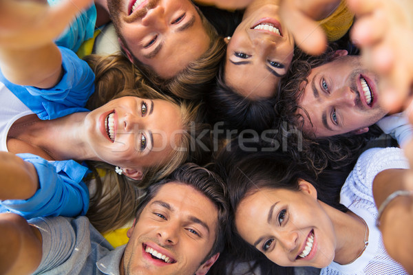 Friends lying together in a circle Stock photo © deandrobot