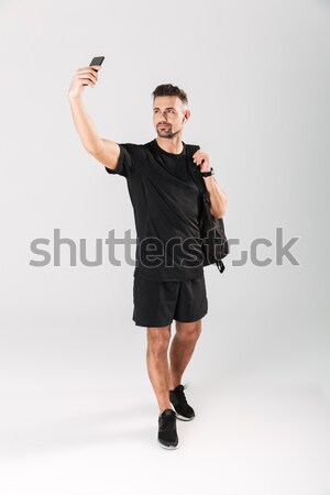 Portrait of a fitness man making selfie photo Stock photo © deandrobot