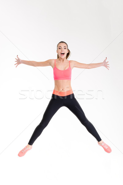 Schönen heiter jungen Sportlerin springen Luft Stock foto © deandrobot