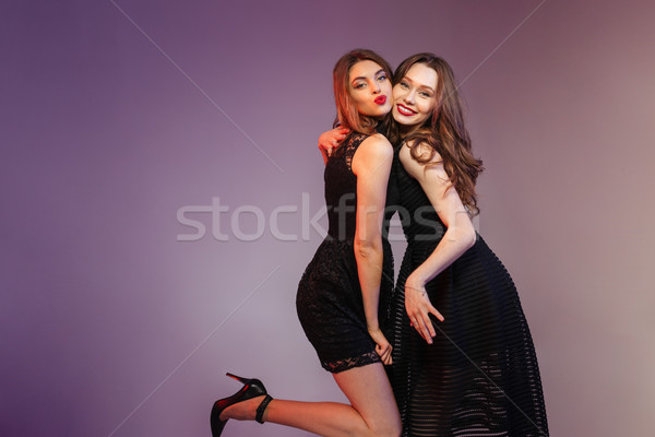 счастливым две женщины ночь черное платье позируют Purple Сток-фото © deandrobot