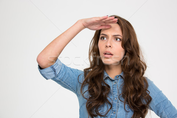 Thoughtful woman with hand at her forehead looking far away  Stock photo © deandrobot