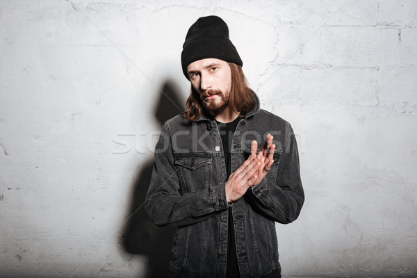 Young handsome hipster with beard and mustache looking at camera Stock photo © deandrobot