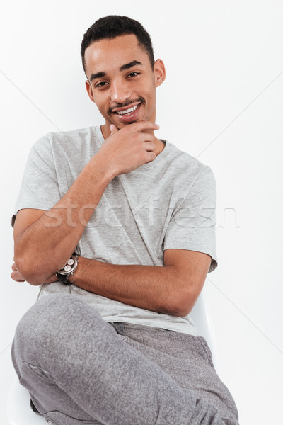 Cheerful young dark skinned man Stock photo © deandrobot