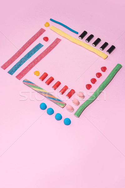 Top view of a colorful sugar candies in a row Stock photo © deandrobot